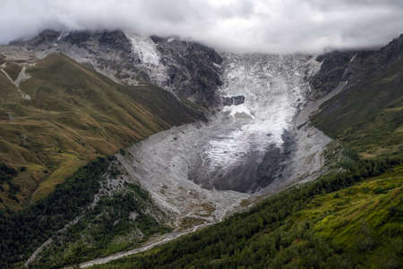 Aerial view to Adishi icefall and tongue with small waterfall on it moraine and kar in mountains of Svaneti Georgiaの写真素材