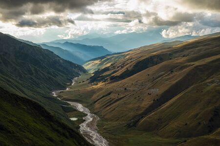 Scenic landscape with mountain river and small lake and blue mountains view from a topの写真素材