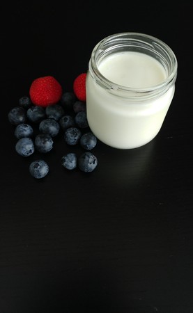 Natural Yogurt in a Glass Jar with Berriesの写真素材