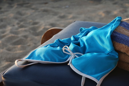 Swimsuit and towel on the beach in the early morningの写真素材