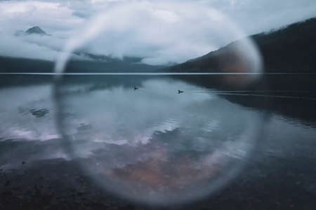 An old woman was playing bubbles near the river. Grebes in the Bowman lake. Camping at bowman lake...