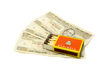 a box of matches on the background of moneyの写真素材