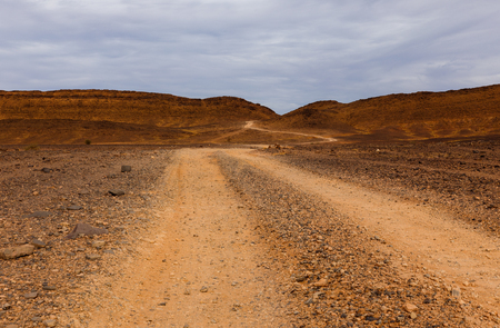 road to the Sahara desert comes to mountains, Moroccoの写真素材