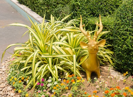 Sculpture of small golden deer grass looking outの写真素材