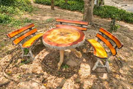 table and three benches in the parkの写真素材