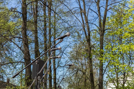 four microphones on the background of treesの写真素材