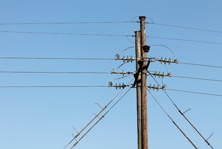 power line supports against a blue sky background.