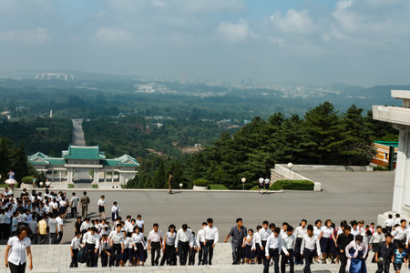 Pyongyang,North Korea-July 27, 2014: Korean schoolchildren climb the stairs at the memorial cemetery...