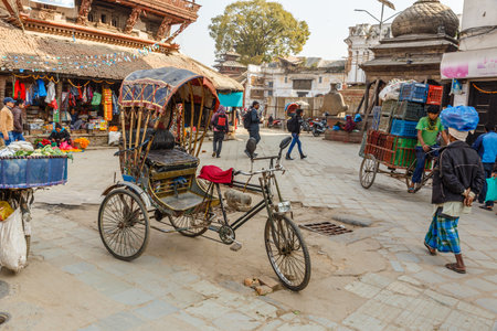 Kathmandu, Nepal - November 25, 2016: A rickshaw stands on Kathmandu Street. In Nepal transport such as pedicabs is still common.のeditorial素材