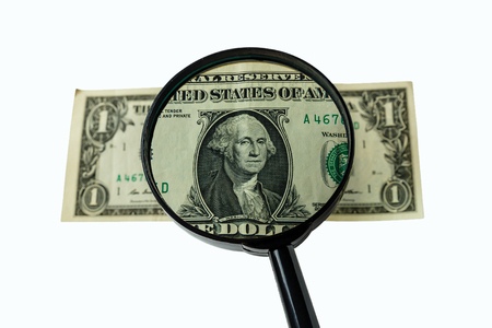 One dollar bill and magnifying glass isolated on white background, obverse front sideの写真素材