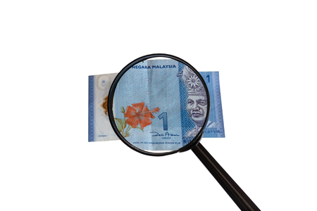 one Malaysia Ringgit and magnifying glass isolated on white background, obverse front side