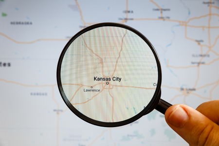 Kansas City, United States. Political map. The city on the monitor screen through a magnifying glass in hand.の写真素材