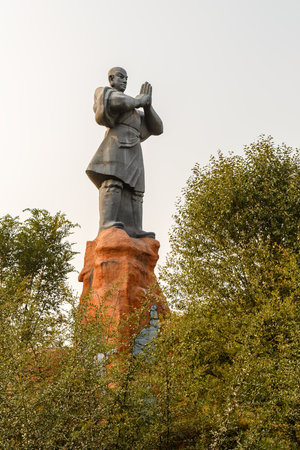 Dengfeng, China - October 17, 2018: Statue of a monk warrior greeting everyone at the entrance to Shaolin monastery.のeditorial素材