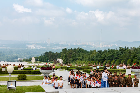 Pyongyang, North Korea - July 27, 2014: Korean schoolchildren and soldiers at the memorial cemetery of revolutionaries in Pyongyang.のeditorial素材