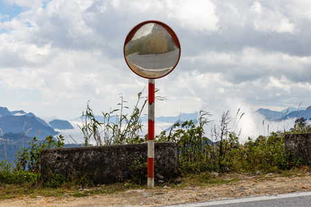 Reflections of the road on traffic mirror for traffic safety. Traffic mirror mountain road, Vietnamの写真素材