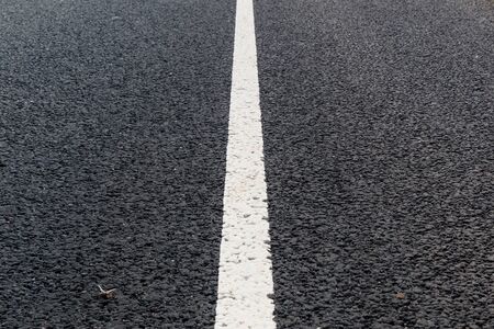White solid line. Road marking on an asphalt road.の写真素材
