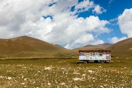 old abandoned wagon in the mountains, nomad wagon, mountains Kyrgyzstanの写真素材