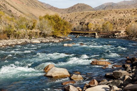Kokemeren river, Djumgal Kyrgyzstan, broken bridge on the riverの写真素材
