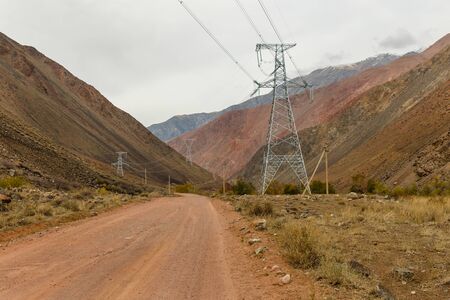 high voltage power transmission pylon in the mountains, high voltage post Mountain landscape, Jumgal...