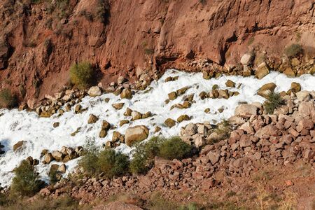 Water in the mountain raging river. Beautiful natural background of stones and water.の写真素材