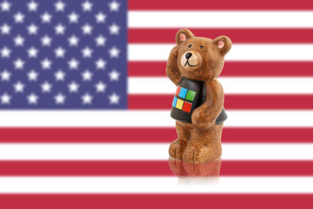 Bear figurine against the background of the USA flag.の写真素材