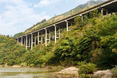 The highway on the Red River is the border between Vietnam and China, Yunnan Province, Chinaの写真素材