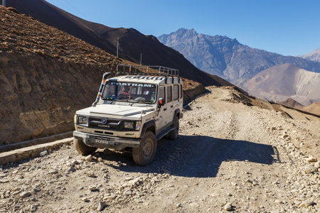 Jharkot, Mustang District, Nepal - November 19, 2016: A broken car stands on a gravel road. Jeep...