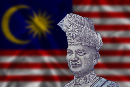 Tunku Abdul Rahman on the background of the Malaysian flag. The portrait of the Prime Minister on the Malaysian one ringgit banknote.の写真素材
