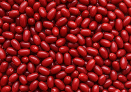 Cornelian cherries are displayed against a textured background, showing their vibrant red color and smooth shape in natural lighting.の素材