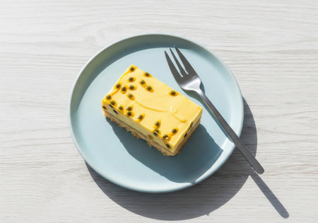 A classic Australian passionfruit slice. This sweet dessert has a biscuit base and a creamy topping with icing and fresh passionfruit seeds.の素材