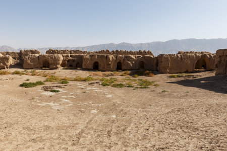 The crumbling mud brick walls of an ancient fortress stand in the arid desert landscape of Balkh Province, northern Afghanistan.の写真素材