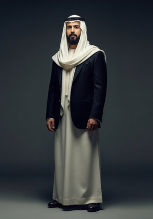 Full length portrait of a modern arab businessman in traditional and western clothing. This confident man represents global business.の素材