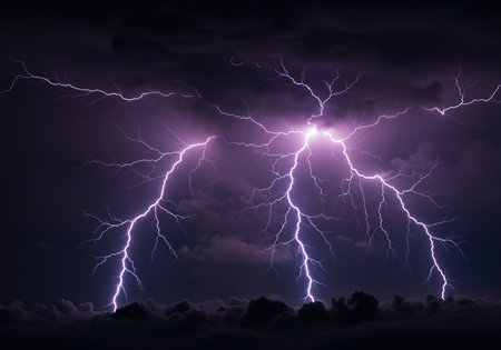 Multiple lightning bolts strike across a dark stormy sky at night. A powerful and dangerous display of natural electrical energy.の素材