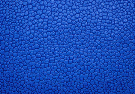 Vibrant blue abstract texture with a pebbled or cellular pattern. A seamless background resembling exotic animal skin or a microscopic view.の素材