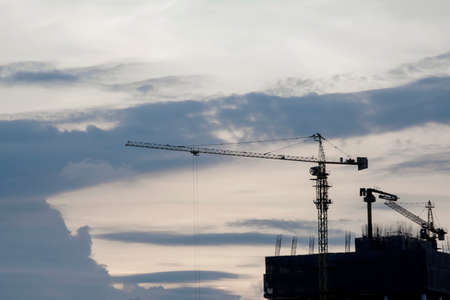 Construction crane in sunset, Construction site and beautiful sky.