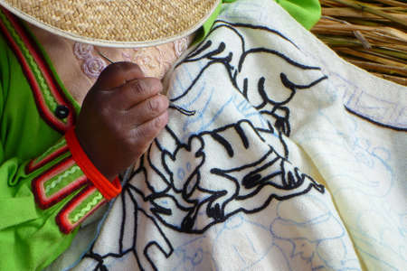 Close-up of a woman knitting on the floating island of Lake Titicaca, Peruの写真素材
