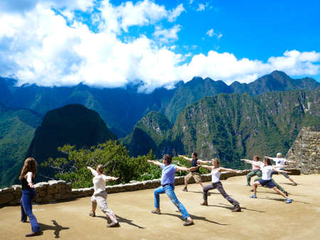 Group doing yoga activity lessons on the premises of Machu Picchu during the dayのeditorial素材