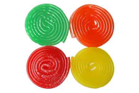 Four spiral candies: green, orange, red and yellowの写真素材