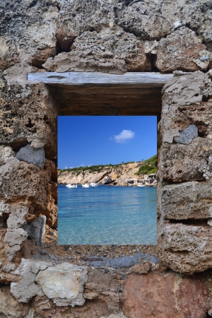View of Ibiza Cala Vadella in through a windowの写真素材