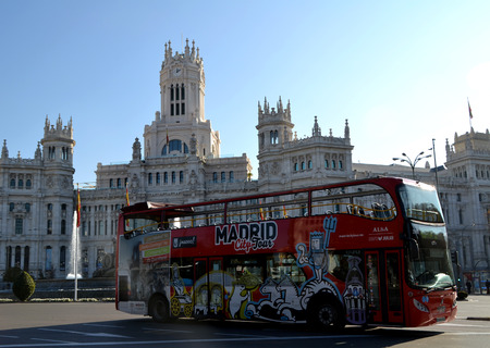 MADRID, SPAIN - DECEMBER 24: Tourist bus in Cibeles Square, Madrid, Spain on December 24, 2014. Madrid City Tour is the official touristic bus service that shows the cityのeditorial素材