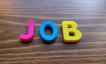 The word Job made with colorful letters on a wooden backgroundの写真素材