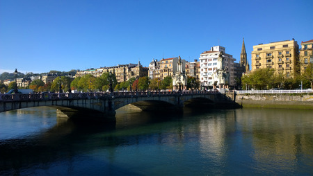 SAN SEBASTIAN, SPAIN - OCTOBER 23: People at Maria Cristina bridge in San Sebastian, Spain on October 23, 2015. It was opened in 1905 for San Sebastian Day and it have four impressive obelisks.のeditorial素材