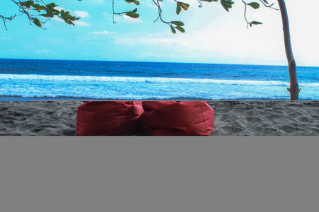 Senggigi beach with blue sea and white sand and place to rest in redの写真素材