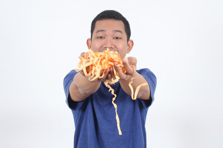 happy asian man show a piece of yellow wrapping paper in his hand to the camera