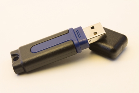 A blue and black USB jump drive with its cap 