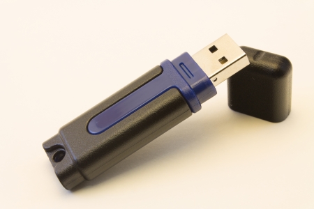 A blue and black USB jump drive with its cap の写真素材