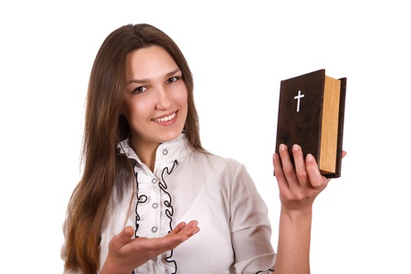 A young girl holding a bible in her handsの写真素材