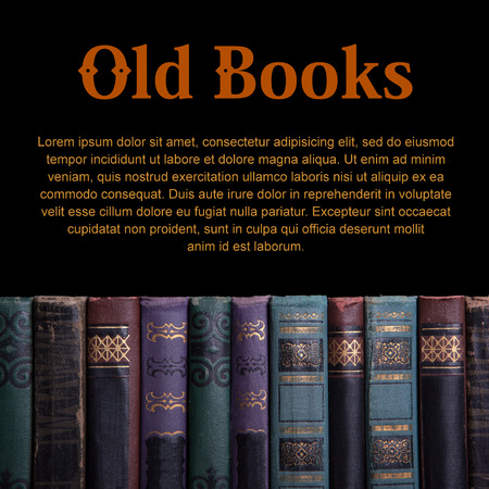 Decrepit old vintage book compiled in a row on a black backgroundの写真素材