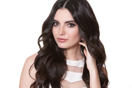 Portrait of young beautiful girl with long hair on the white background.の写真素材