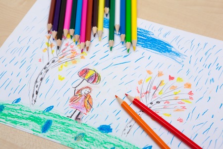 Children pencil drawing. Girl with an umbrella in the rain and the tree. Themes of nature protection and peaceの写真素材